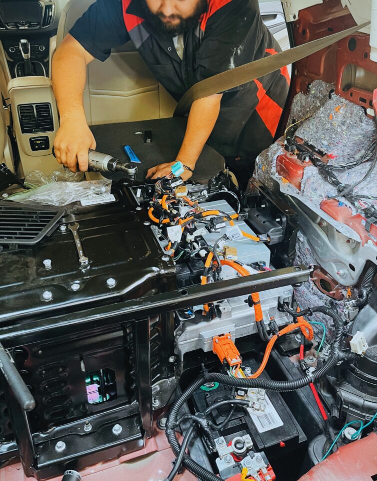 Tucson Hybrids mechanic performing hybrid battery repair and diagnostics on electric vehicle in Tucson, AZ